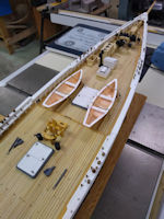 Dories on deck with white railings and thwart boards. Looks better!