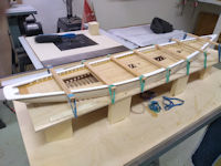 Bluenose in framing jig with main railing glued to the hull